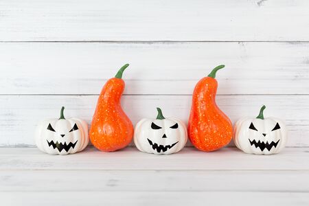White ghost and Orange pumpkin on white wood table with copy space.の写真素材