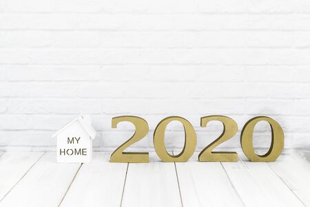 2020 new year and home  on white wood table over white background with copy space , Real estate conceptの写真素材