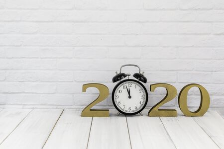 2020 new year & alarm clock on white wood table over white background with copy space , time conceptの写真素材