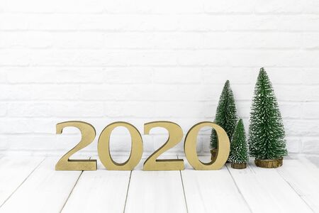 2020 new year and christmas tree on white wood table over white background with empty spaceの写真素材