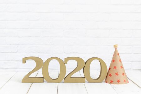 2020 new year and party hat on white wood table over white background with copy spaceの写真素材