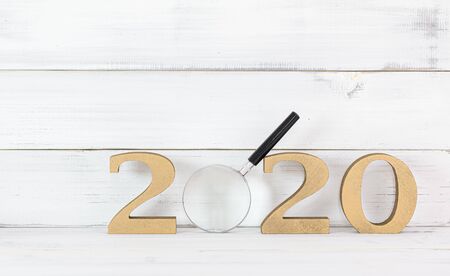Upcoming 2020 New Year with Magnifying glass over white wood background, Search Goals Conccept.の写真素材
