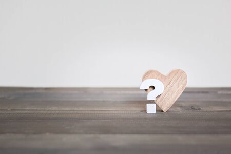 Question mark with Heard on wood table , Problem Concept