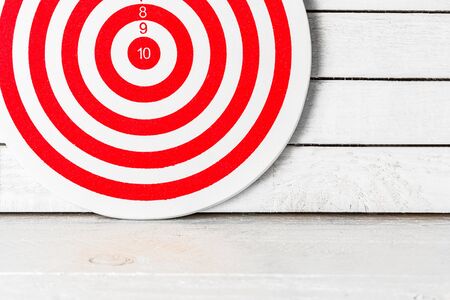 Dartboard on white wood.の写真素材