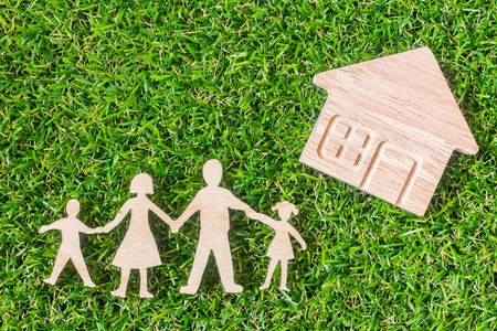Wood Family Shaped and Home Shaped on green grass.  Green Family Concept.の写真素材