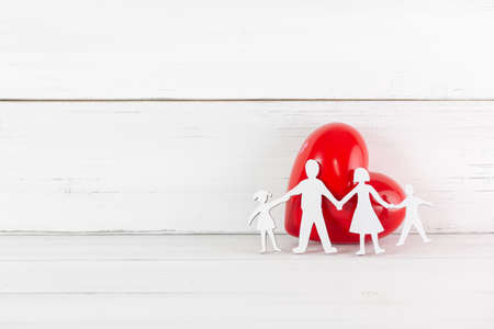 Red Heart with Wood Family Shaped on white wood background. Happy Love Concept with Copy Space.の写真素材