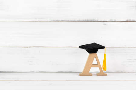 Education Hat with A Alphabet on white wood background.の写真素材