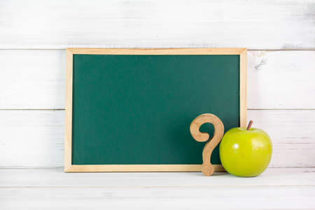 Greenboard , Green Apple and question mask sign on white wood background , empty board , problem and solving Education concept.の写真素材