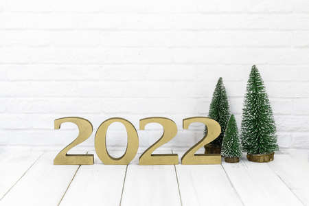 2022 new year and christmas tree on white wood table over white background with empty spaceの写真素材