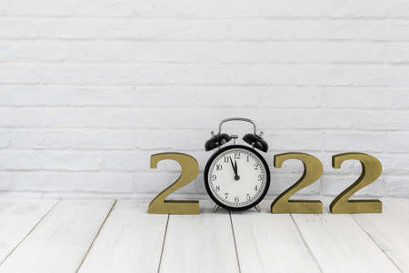 2022 new year & alarm clock on white wood table over white background with copy space , time conceptの写真素材