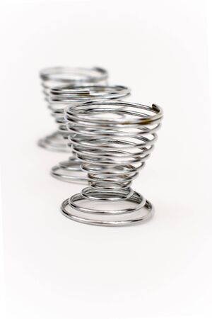 Three silver eggs holder on a white backgroundの写真素材