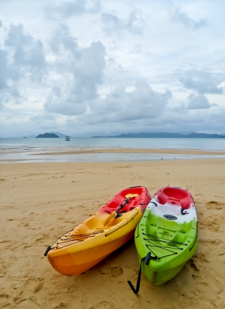 The two kayak on the cloudy beachの写真素材