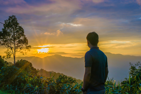 Man watching the sunset at the mountian.の写真素材