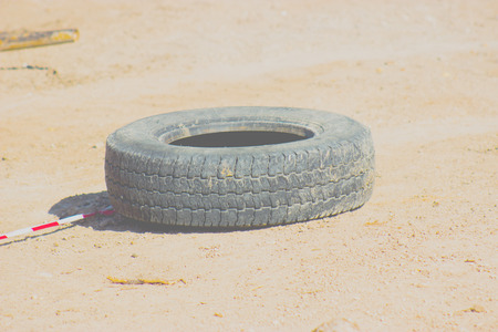 The wheel of the car lies on the ground