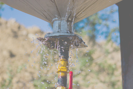 Water runs out of the drop pipeの写真素材
