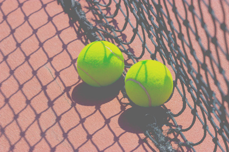 Tennis balls near the gridの写真素材