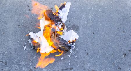 burning paper on the ground, polluted ecologyの写真素材