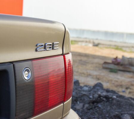 red and black in a gray car, rear view