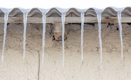icicles under the roof of the house