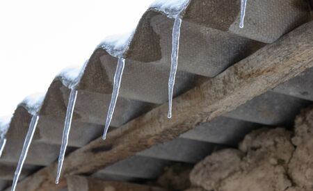 icicles under the roof of the house
