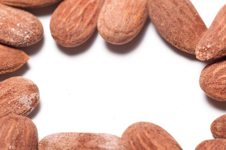 Group of almonds on a white background with copyspace in the middleの写真素材