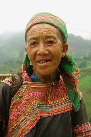 This grandmother was part medicinal plants. Obviously very poor, she still wanted to offer me a handful of grass!の写真素材