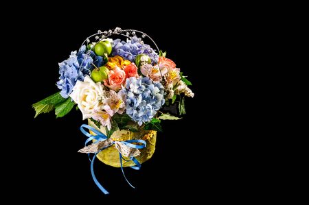 Little bouquet of flowers in the can on black backgroundの写真素材
