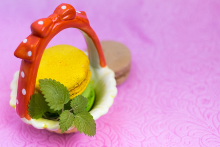 Macaroons fresh colorful close up. French dessert food. Beautiful cakes on pastel background.