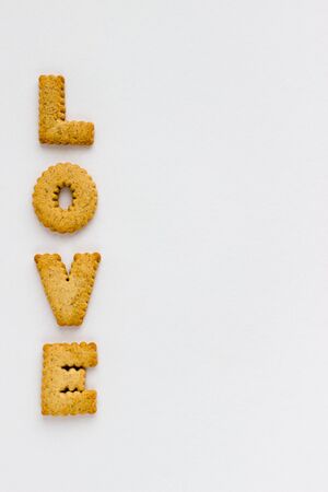 Love Lettering with Cookies on White Background. Top View Baked Letters Design Template.の写真素材