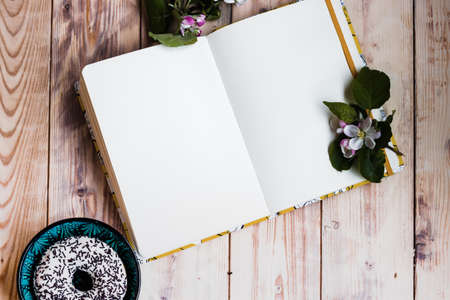 Open notebook on wooden background mock-up. Empty sketchbook, ideas writing, planning, home office,...