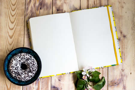 Open notebook on wooden background mock-up. Empty sketchbook, ideas writing, planning, home office,...