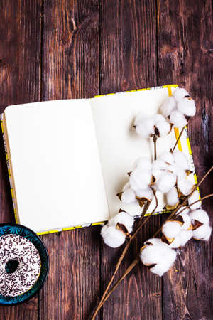 Open notebook on wooden background mock-up. Empty sketchbook, ideas writing, planning, home office, freelance, artwork.の写真素材