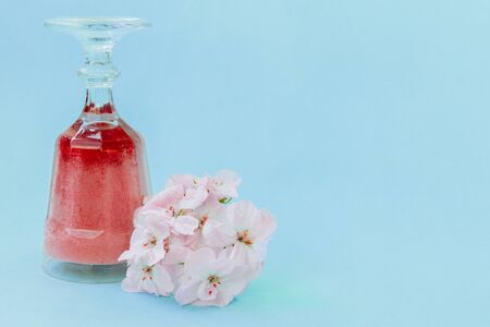 The crystal glass is upside down. The glass contains a gradient raspberry smoothie. Next to it is a...