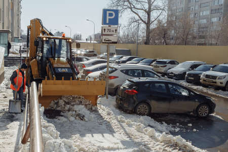 03.28.2020. Russian Federation. Samara Snow cleaning in a residential area in the parking lot in the...