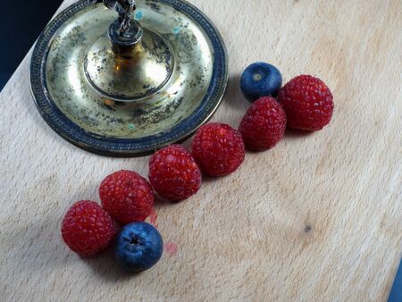 Blueberries and Raspberries on a chopping board
