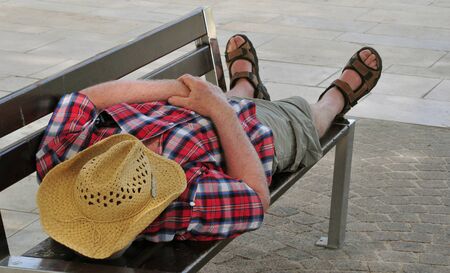 Bandol, France - april 20 2016 : an old man is sleeping on a benchのeditorial素材