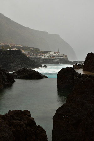 Porto moniz, Madeira, Portugal - february 25 2018 : natural pool in volcanic rockの写真素材