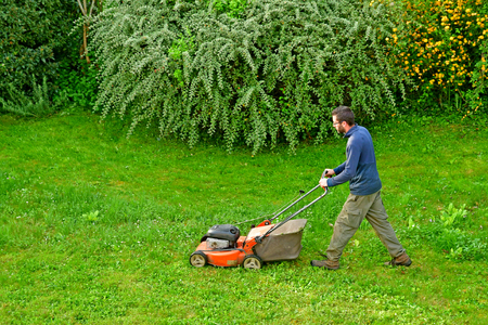 Verneuil sur Seine; France - may 17 2017 : a gardener is cutting lawnのeditorial素材