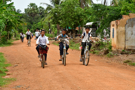 Kampong Chhnang; Kingdom of Cambodia - august 21 2018 : kid are going to school in the picturesque villageのeditorial素材