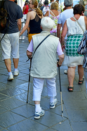 Granada; Spain - august 27 2019 : an old woman is walking with sticksのeditorial素材