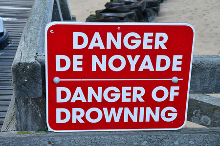 Trouville sur Mer, France - september 27 2019 : a danger of drowing sign on the pierのeditorial素材
