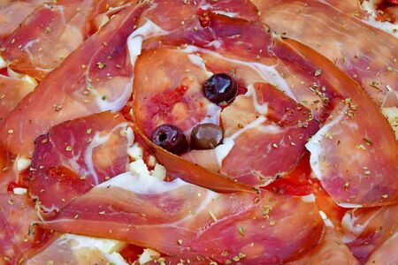 a close up of pizza before being bakedの写真素材