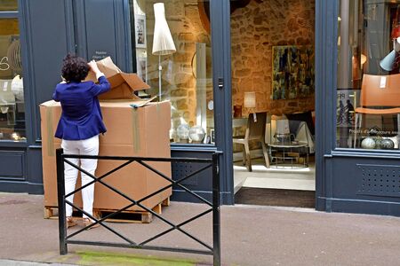 Saint Germain en Laye; France - august 7 2019 : woman with a cardboard boxのeditorial素材