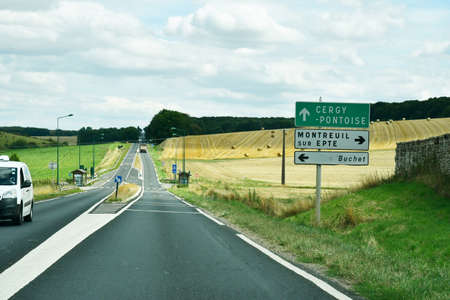 Les Thilliers en Vexin, France - august 8 2019 : the D 6014 road between Magny en Vexin and Fleury sur Andelleのeditorial素材