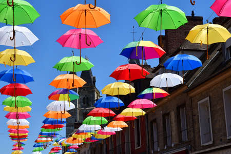 Les Andelys; France - july 2 2019 : the Marcel Lefevre street decorated with multicoloured umbrellasのeditorial素材