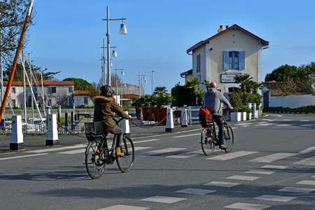 Ars en Re, Ile de Re,France - march 13 2020 : cyclist in the picturesque villageのeditorial素材