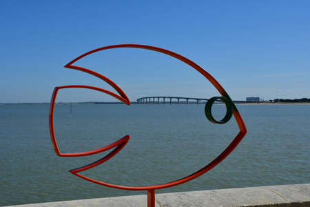 Rivedoux Plage, ile de Re, France - march 13 2020 : modern sculpture of a fish near the picturesque seasideのeditorial素材