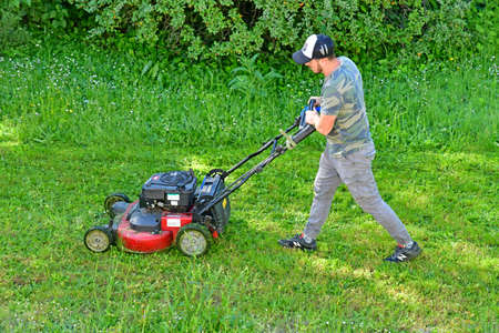 Le Tour du Parc, France - june 6 2021: a gardener is cutting lawnのeditorial素材