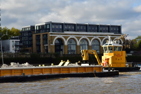 London; England - October 21 2021: A rubble barge on the Thames river