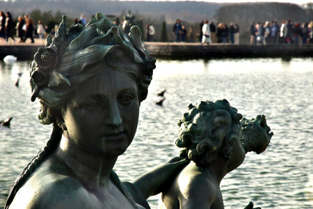 Versailles; France - November 26 2024: the castle of Louis 14, bronze statue on the water parterreのeditorial素材